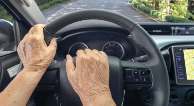 a hand driving a car